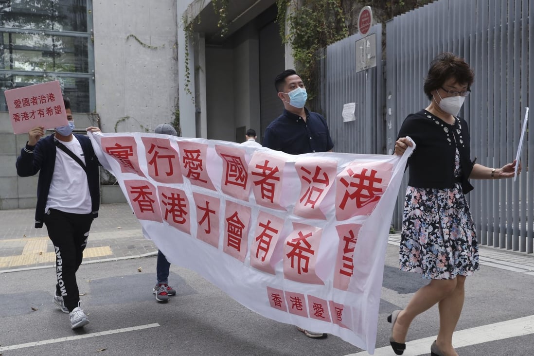 Pro-Beijing groups show support to the move to disqualify four pan-democratic lawmakers, outside Tamar. Photo: SCMP/ Edmond So
