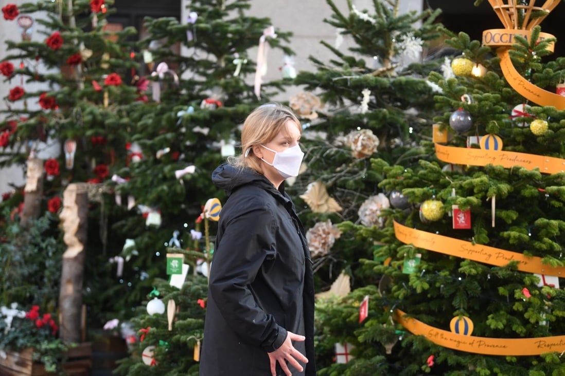 A woman passes Christmas decorations at Covent Garden in London on Monday. Photo: EPA-EFE