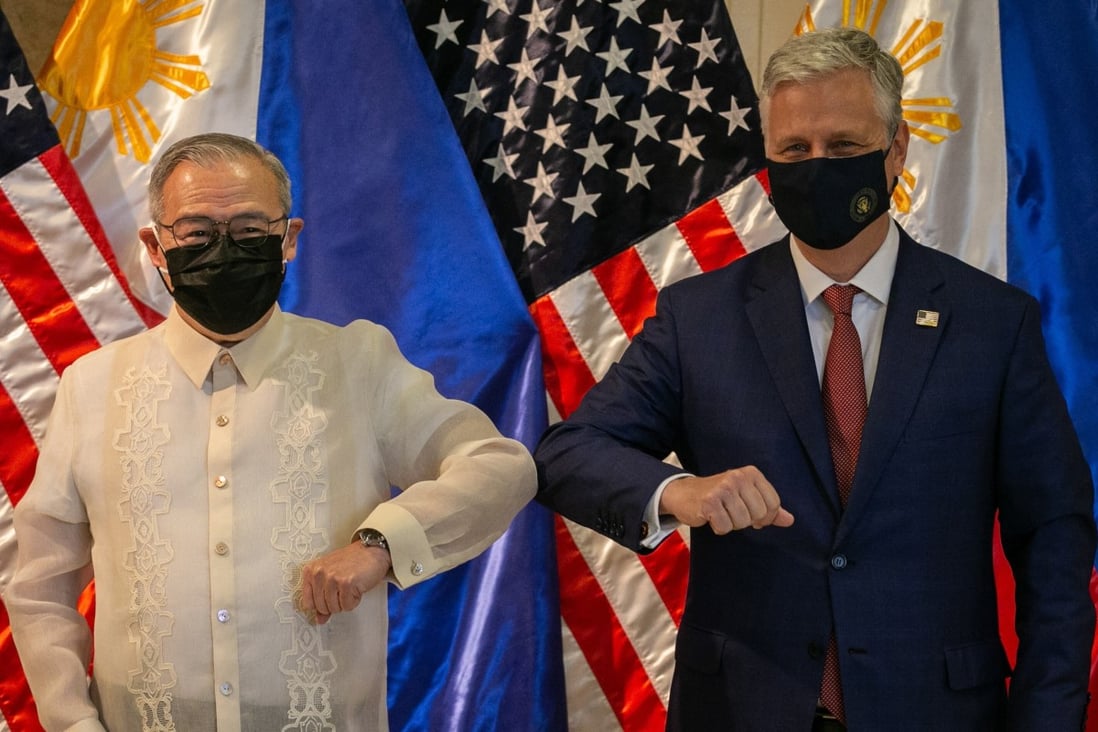 Philippines’ foreign minister Teodoro Locsin bumps elbows with US National Security Adviser Robert O'Brien on Monday. Photo: EPA-EFE