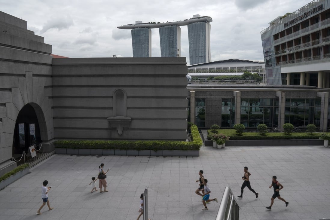 Joggers run by with the Marina Bay Sands Resort in the background in Singapore earlier this week. Photo: EPA