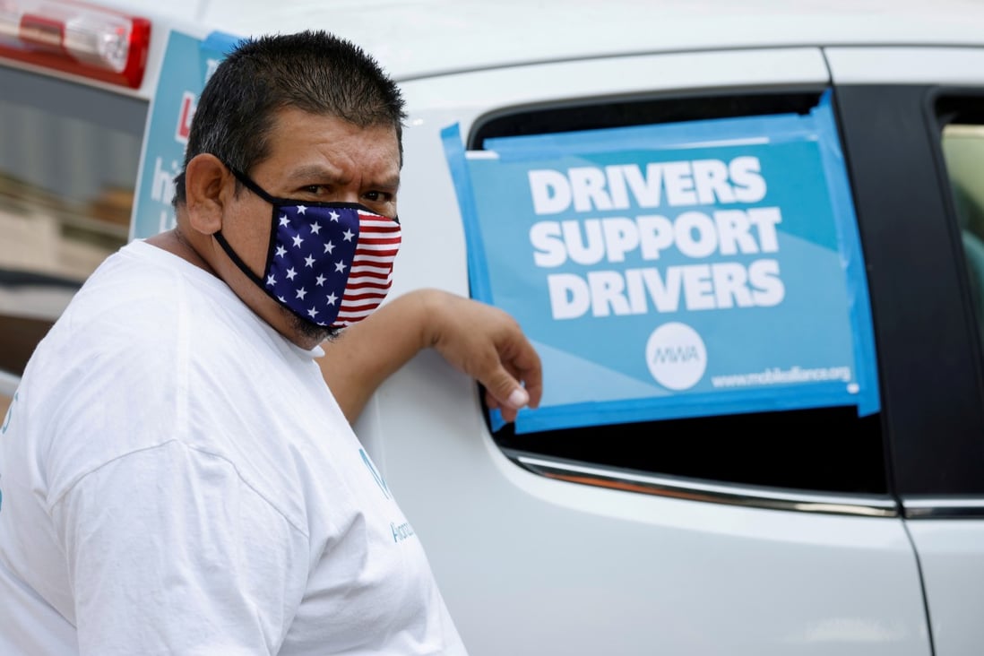 A rideshare driver takes part in a rally as part of a statewide day of action to demand that ride-hailing companies Uber and Lyft grant drivers "basic employee rights'' in Los Angeles, California on August 20, 2020. Photo: Reuters
