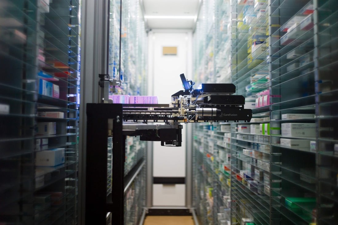 A robot retrieving medicines in the pharmacy of the Argenteuil hospital, in Argenteuil, a Paris suburb, as technology changes how business and services are delivered in pandemic. Photo: AFP