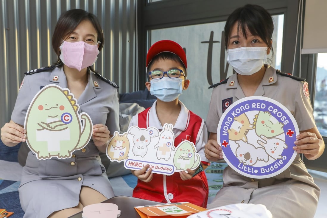 Hong Kong Red Cross staff officer Sandy Wong (left) and senior staff officer Heidy Lung (right) with student Jovon Lee, a member of the Red Cross Little Buddies programme in West Kowloon. Photo: K. Y. Cheng
