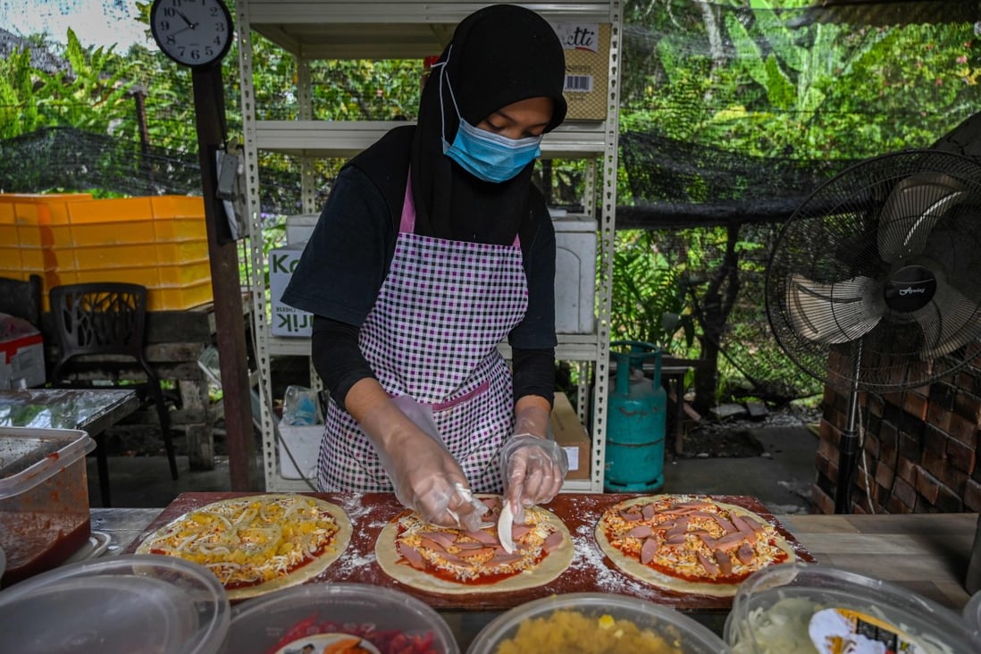 A worker preparing pizza ingredients at the Jemapoh pizzeria in Malaysia’s Negeri Sembilan state. Photo: AFP