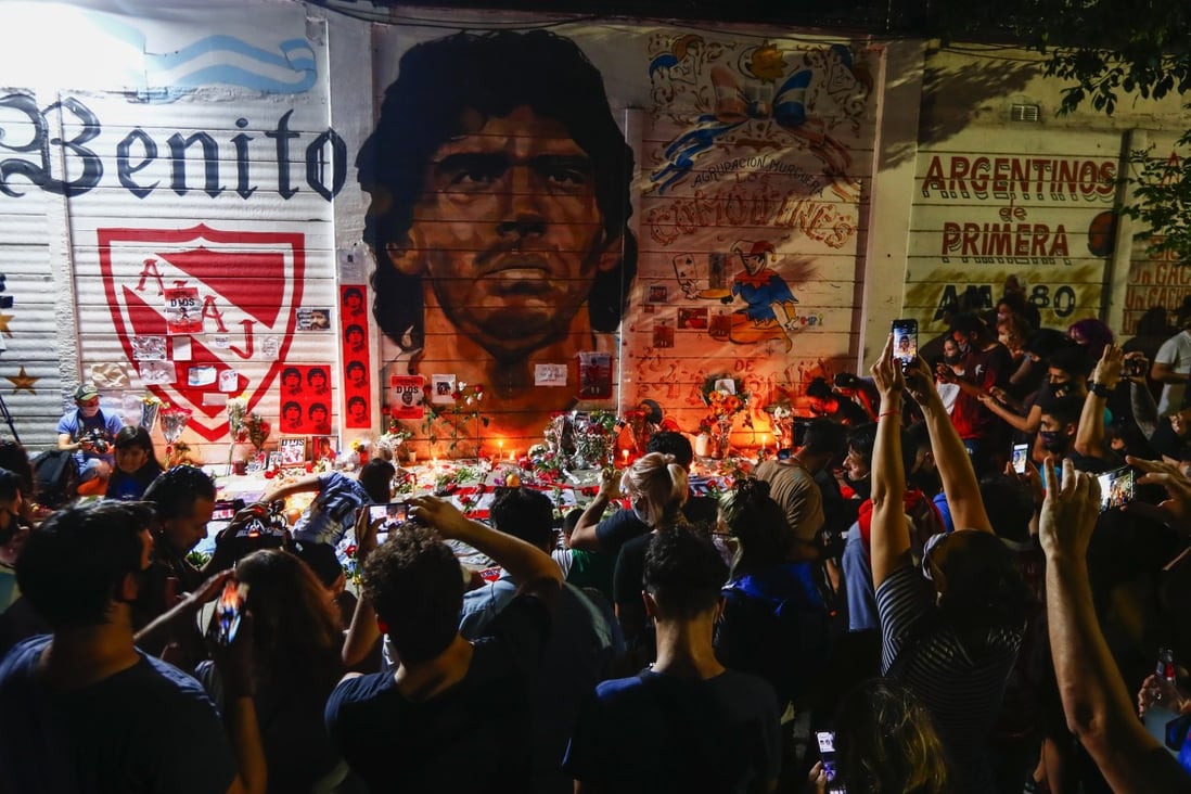 Fans hold a vigil for Diego Maradona outside the stadium of Argentinos Juniors, where he started as a professional. Photo: AP