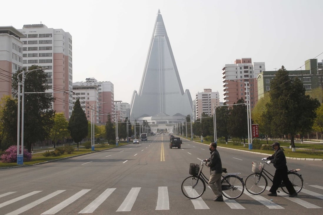 People wearing face masks cross a road in Pyongyang, North Korea. Photo: AP