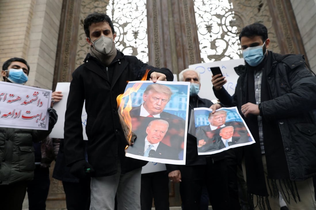 Protesters burn pictures of US President-elect Joe Biden and US President Donald Trump during a demonstration against the killing of Mohsen Fakhrizadeh. Photo: West Asia News Agency via Reuters