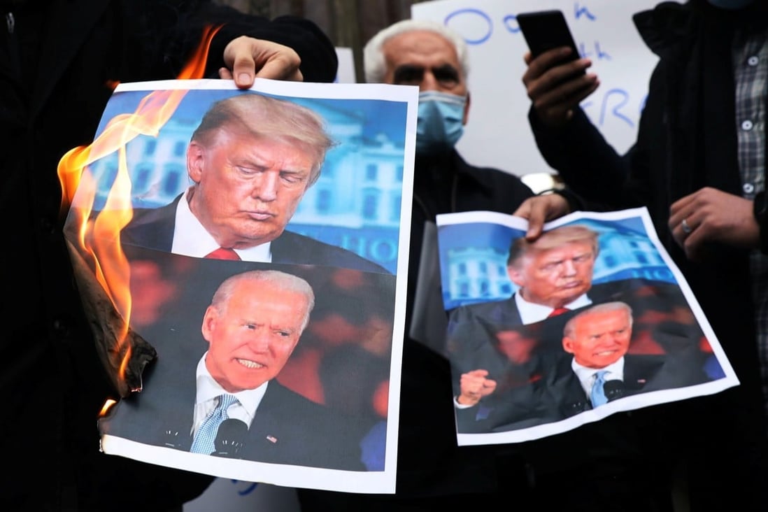 Protesters burn pictures of US President-elect Joe Biden and President Donald Trump during a demonstration against the killing of Mohsen Fakhrizadeh on Saturday. Photo: Reuters