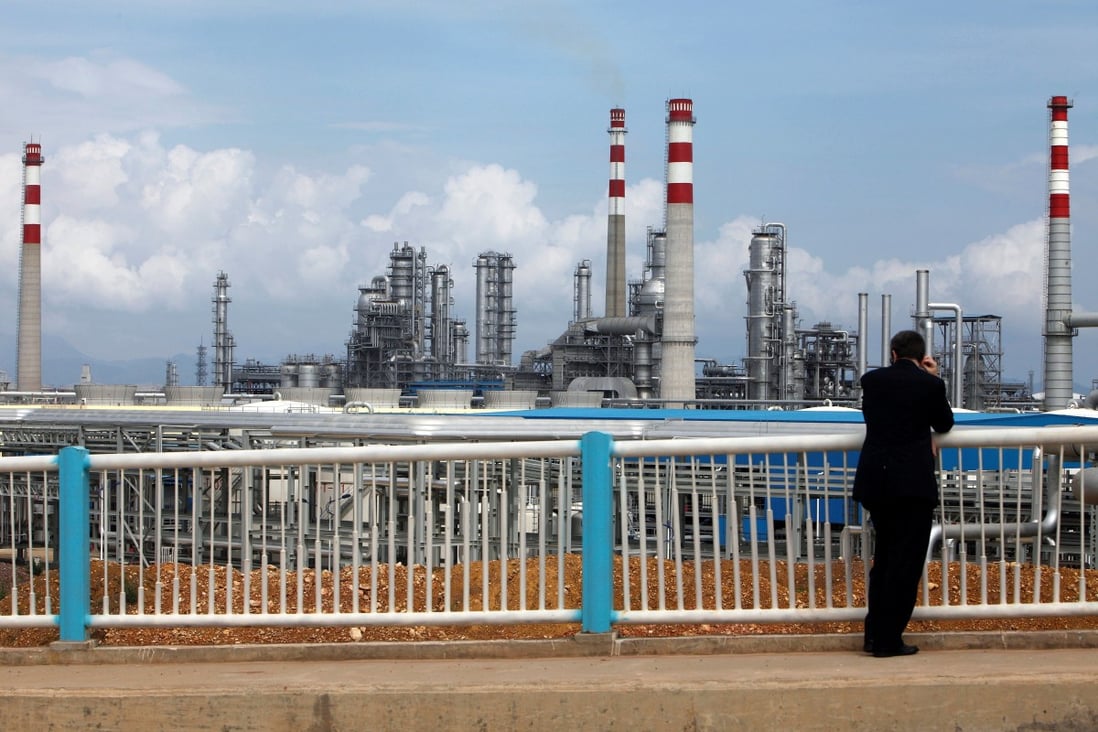 A visitor looks at China National Offshore Oil Corporation's oil refinery in Huizhou in southern Guangdong province. The state-linked oil explorer faces possible new US sanctions. Photo: Reuters