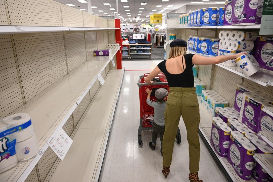 A shopper picks up a package of toilet paper at a store in Burbank, California, on November 19. Paper towels and other cleaning supplies are flying off retail shelves amid a new wave of panic buying as the United States faces the most recent surge in coronavirus infections. Photo: AFP