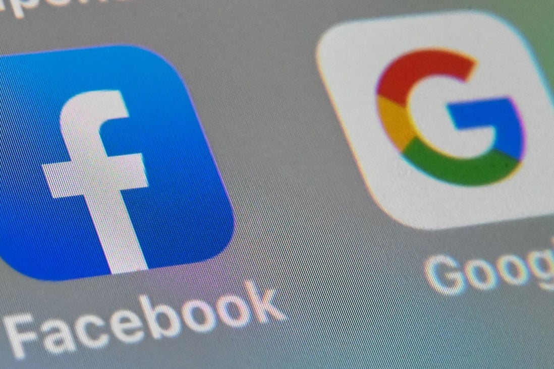 The logos of Facebook and Google’s mobile apps displayed on a tablet PC. Photo: AFP