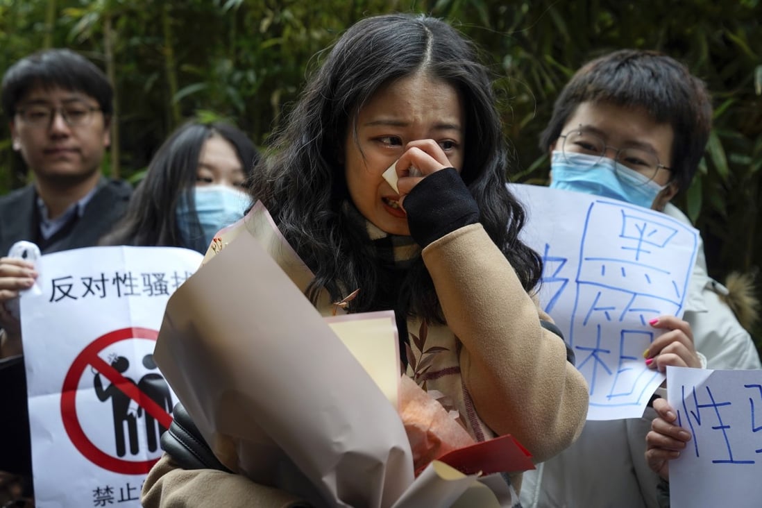 Zhou Xiaoxuan, centre, cries as she speaks to her supporters upon arrival at the courthouse in Beijing. Photo: AP