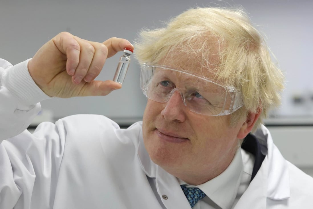 British Prime Minister Boris Johnson holds up the AstraZeneca-Oxford coronavirus vaccine on a visit to pharmaceutical and biotech company Wockhardt in Wales. Photo: No 10 Downing Street handout via dpa