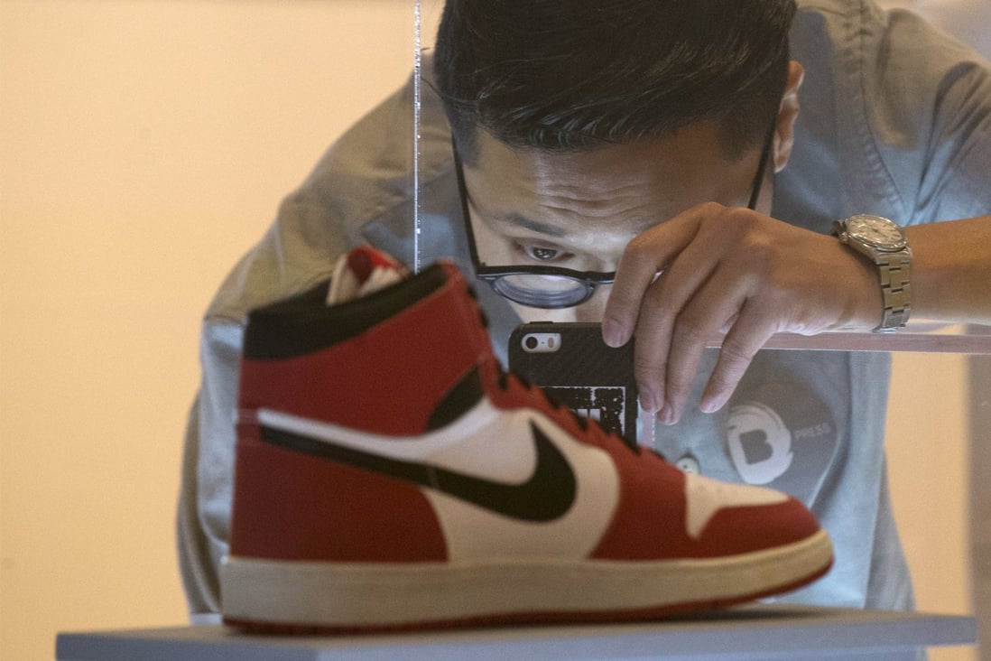 A visitor photographs an Air Jordan I during a preview for “The Rise of the Sneaker Culture” exhibit at the Brooklyn Museum in New York in July, 2015. Photo: Reuters