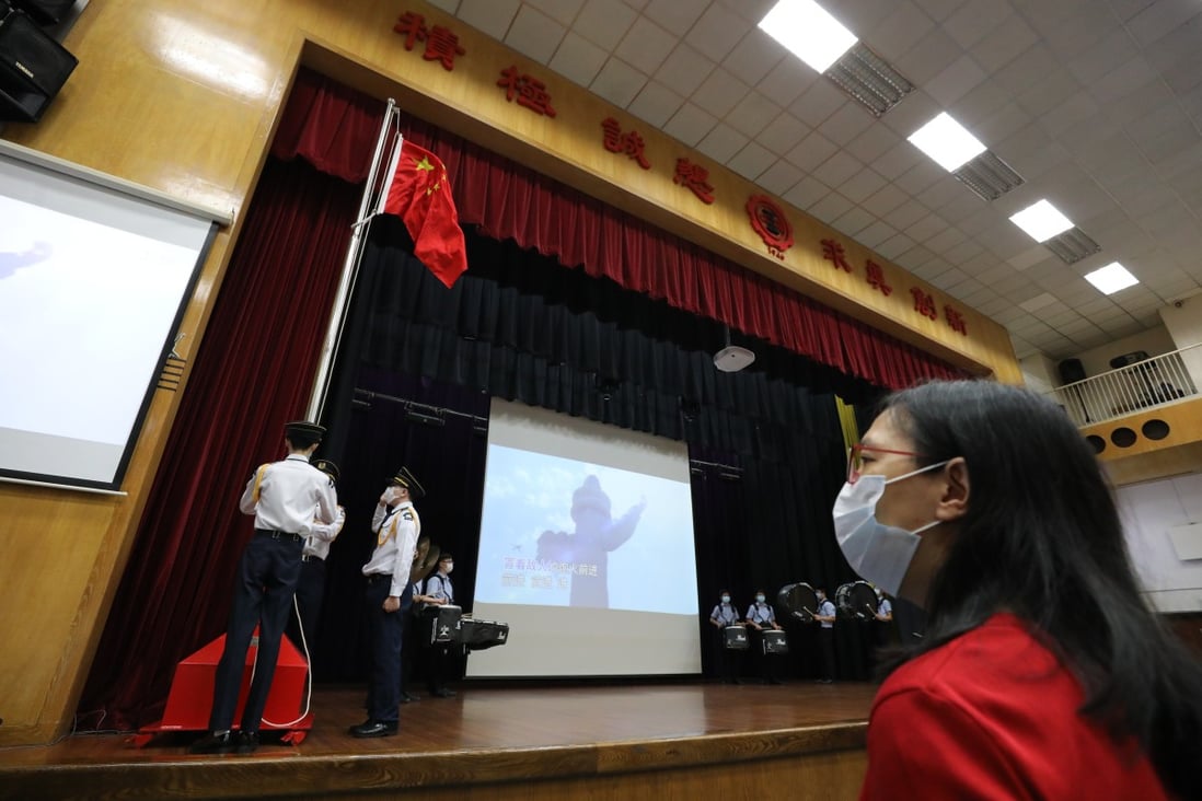 A flag-raising raising ceremony takes place at a secondary school in Ho Man Tin the day after the national security law was adopted. Photo: May Tse