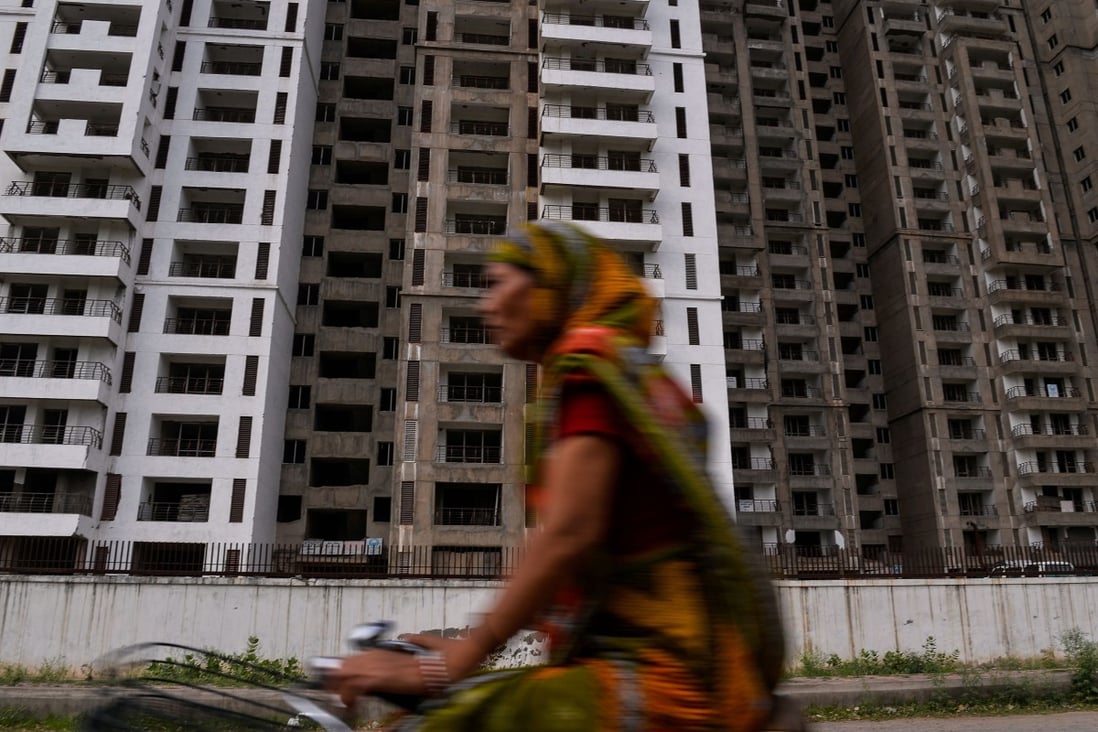 A cyclist rides past residential apartments under construction in Greater Noida, some 25km southeast of New Delhi, in 2017. India’s new Reit market facilitates tie-ups between liquidity-starved developers and risk-averse investors. Photo: AFP