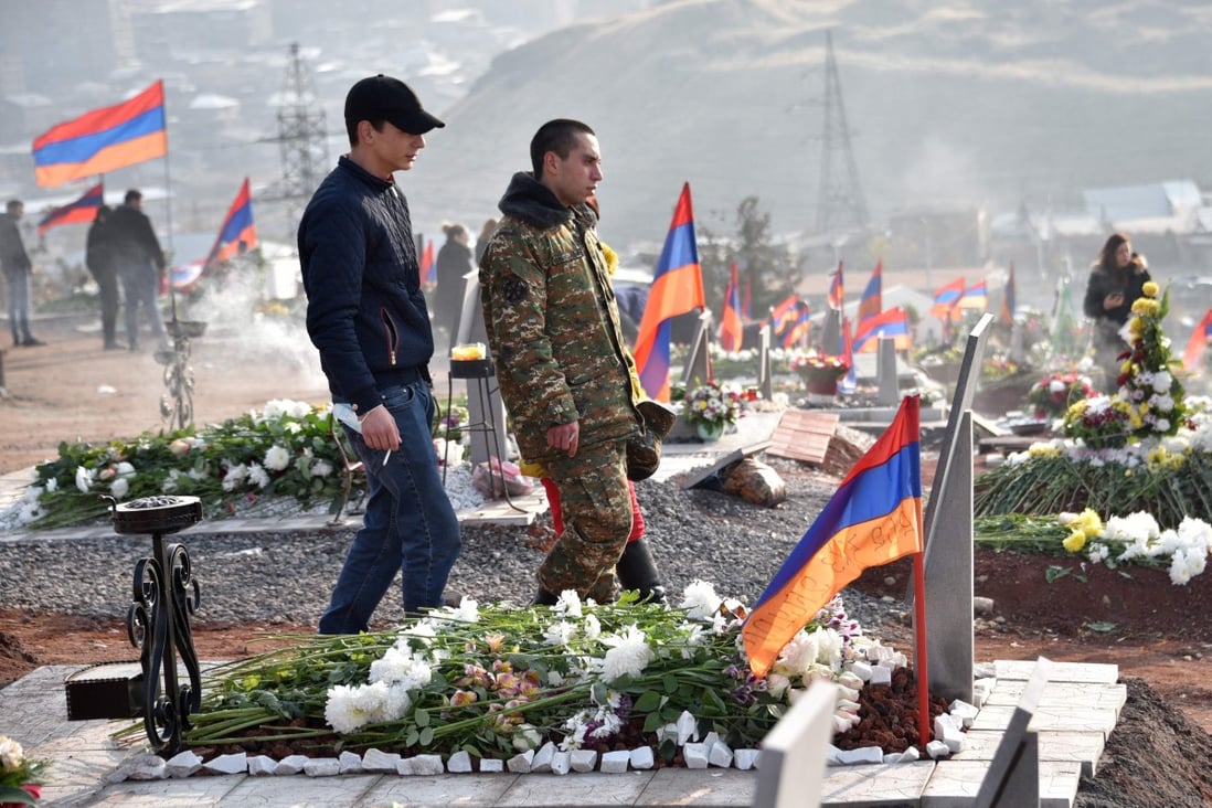 People visit the graves of their relatives killed during the Karabakh conflict in Yerevan, Armenia, on Saturday. Photo: AFP