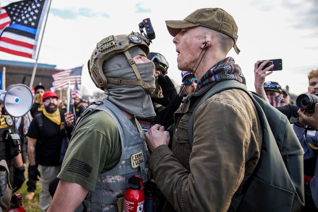 A member of the Proud Boys clashes with a member of Antifa during a protest in support of President Donald Trump in Washington on Saturday. Photo: dpa
