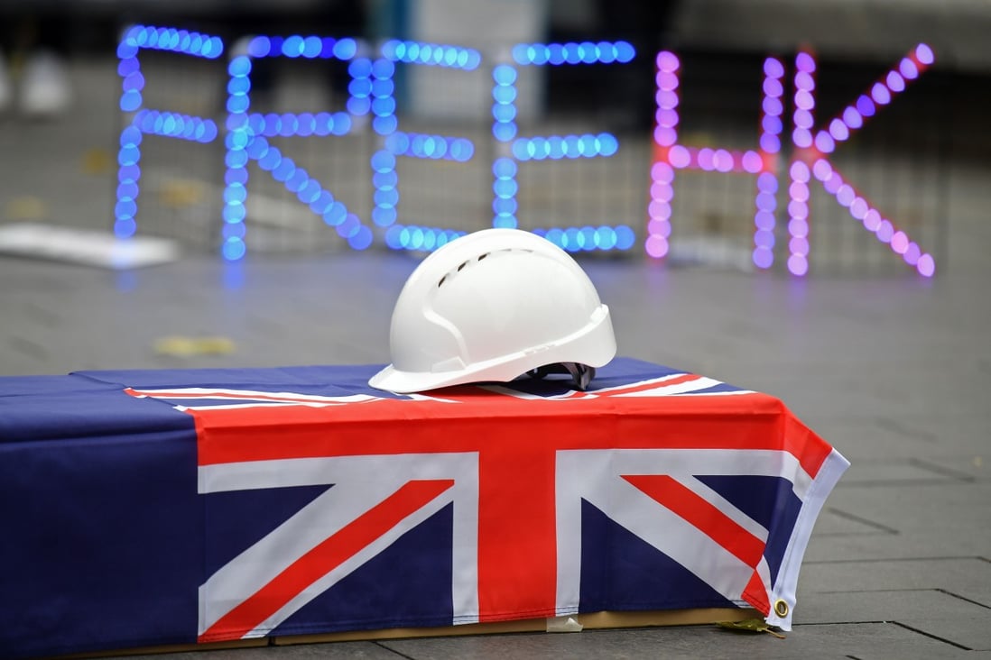 A hard hat is seen on a coffin as protesters gather at an event on December 12 in central London, organised by Justitia Hong Kong, to mourn the loss of Hong Kong's political freedoms. Issues like Hong Kong, Xinjiang, Taiwan and the South China Sea, which are for China issues of sovereignty, are understood by the UK as important issues of international law and human rights. Photo: AFP