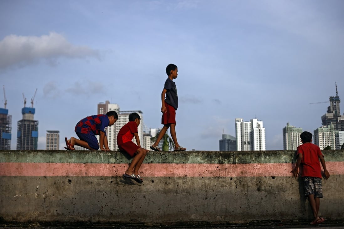 Indonesian boys play in a slum area of Jakarta in February. Millions of Indonesians have been left vulnerable to poverty by the pandemic. Photo: EPA