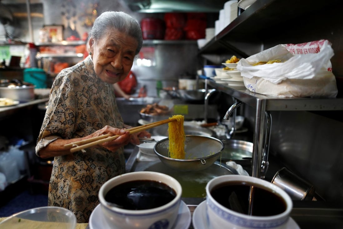 Hawker Leong Yuet Meng of Nam Seng Noodle House cooks at her shop in Singapore in February 2019. Photo: Reuters