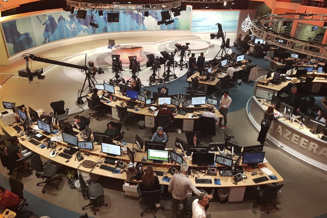 Al-Jazeera staff work at their TV station in Doha, Qatar. File photo: AP