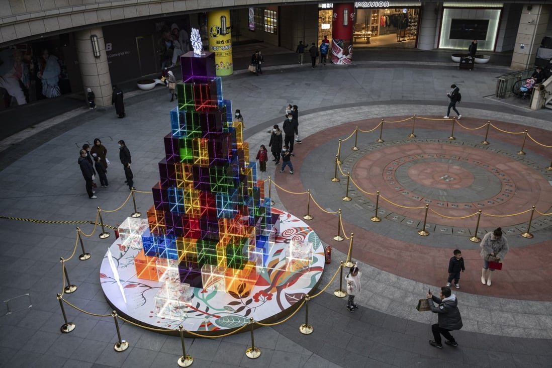 An modern take on a Christmas tree towers over visitors outside a Shanghai shopping mall. Photo: Bloomberg