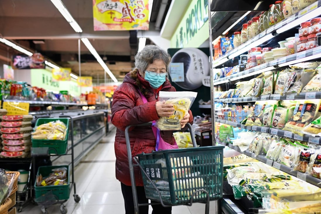 An elderly woman shops at a supermarket in Beijing on December 17. Photo: AFP