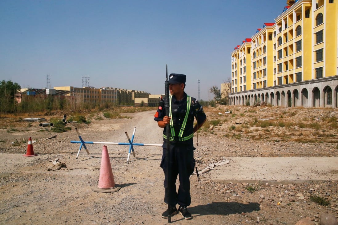 A Chinese police officer near what is officially called a ‘vocational training centre’ in Xinjiang on September 4, 2018. Photo: Reuters