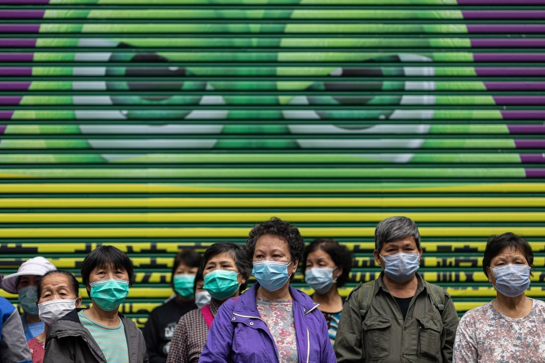 Street cleaners wait in line to receive free face masks in Hong Kong on February 14. Photo: EPA-EFE