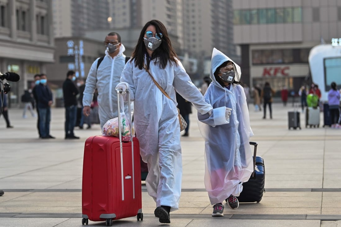 People wearing protective clothing and masks arrive at Hankou Railway Station in Wuhan in April. Photo: AFP