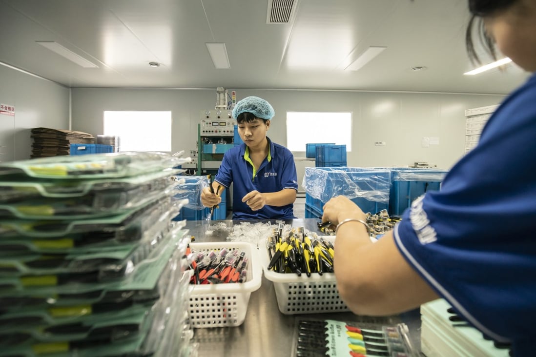 Employees sort toothbrushes on a production line in Yangzhou, Jiangsu Province, China. Photo: Bloomberg