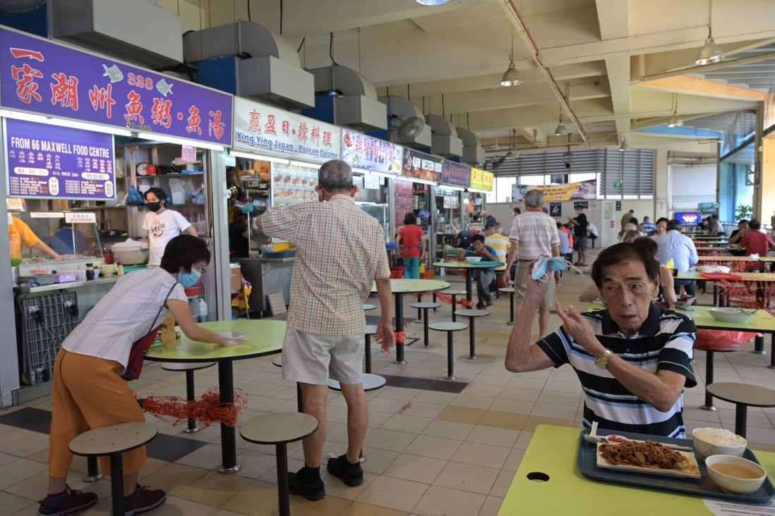 Singaporeans gather cautiously as coronavirus restrictions ease during