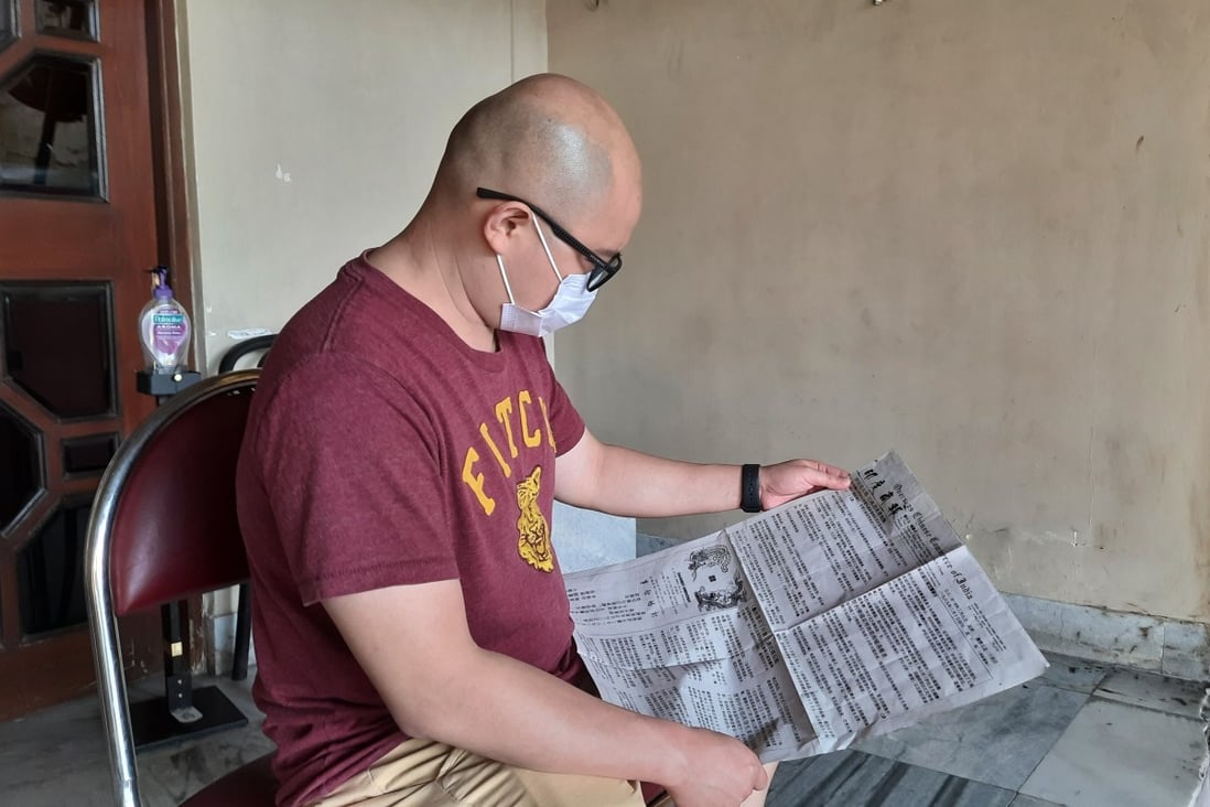 A member of Kolkata’s Chinese community shows the edition of the Overseas Chinese Commerce of India – the country’s last Chinese-language newspaper – that carries his engagement announcement. Photo: Rakesh Kumar