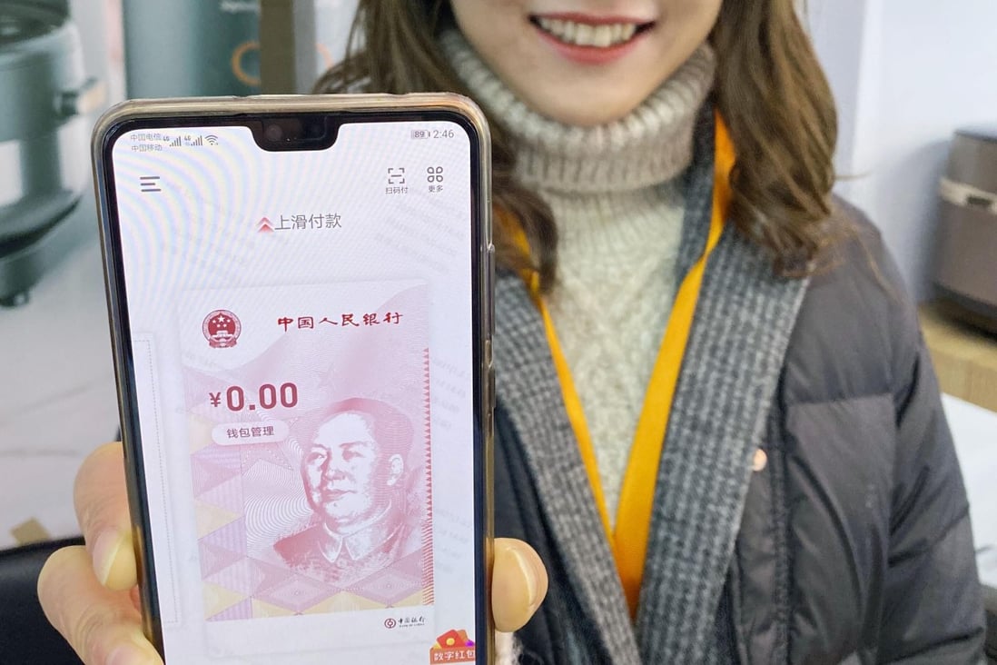 A woman in Suzhou, China, shows a smartphone app that allows its user to buy things with the digital yuan. This is part of an ongoing trial of the new currency. Photo: Kyodo