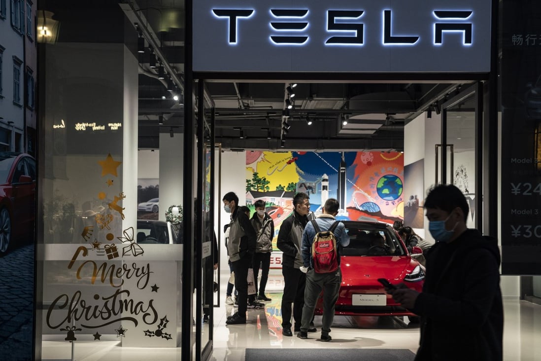 Shoppers and employees inside a Tesla showroom in Shanghai. Photo: Bloomberg
