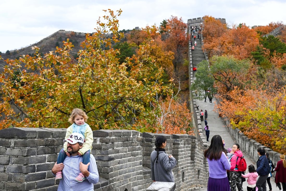 Tourists take in the autumn scenery at the Mutianyu section of the Great Wall on the outskirts of Beijing. Photo: Xinhua