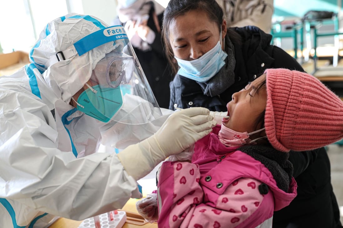 A medical worker takes a swab sample from a child to test for Covid-19 in Shenyang, China’s northeast Liaoning province on Thursday. Photo: AFP