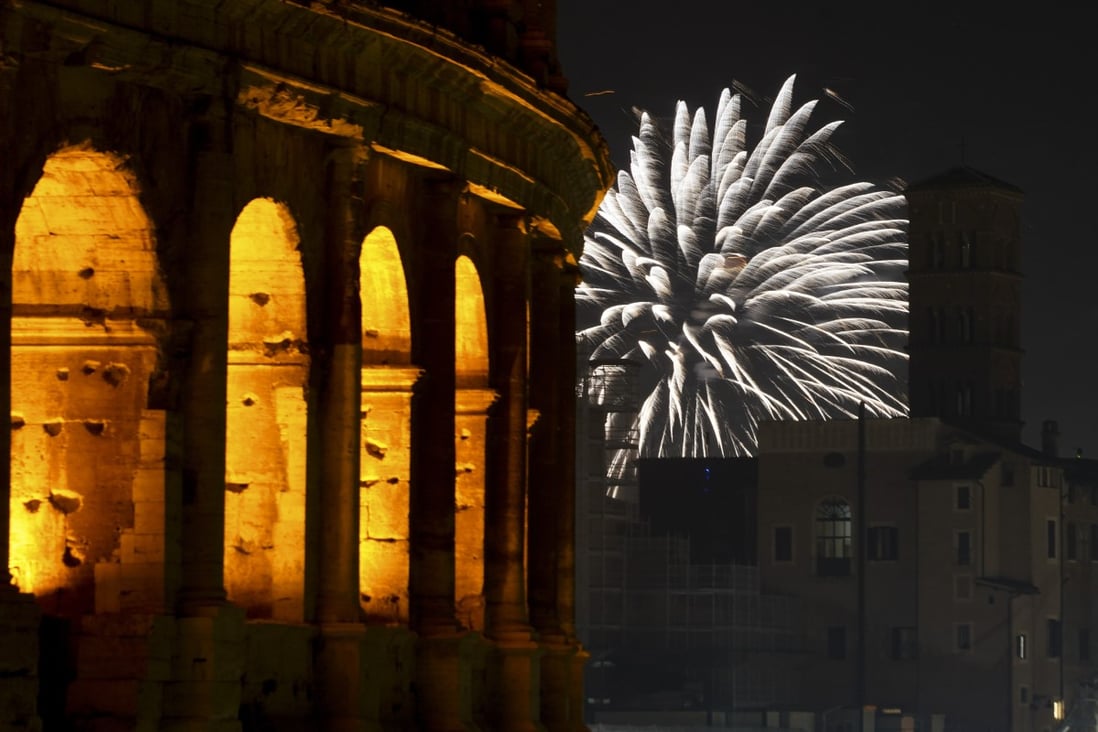 Fireworks explode in the sky next to Rome’s Colosseum on New Year’s Eve. Photo: AP