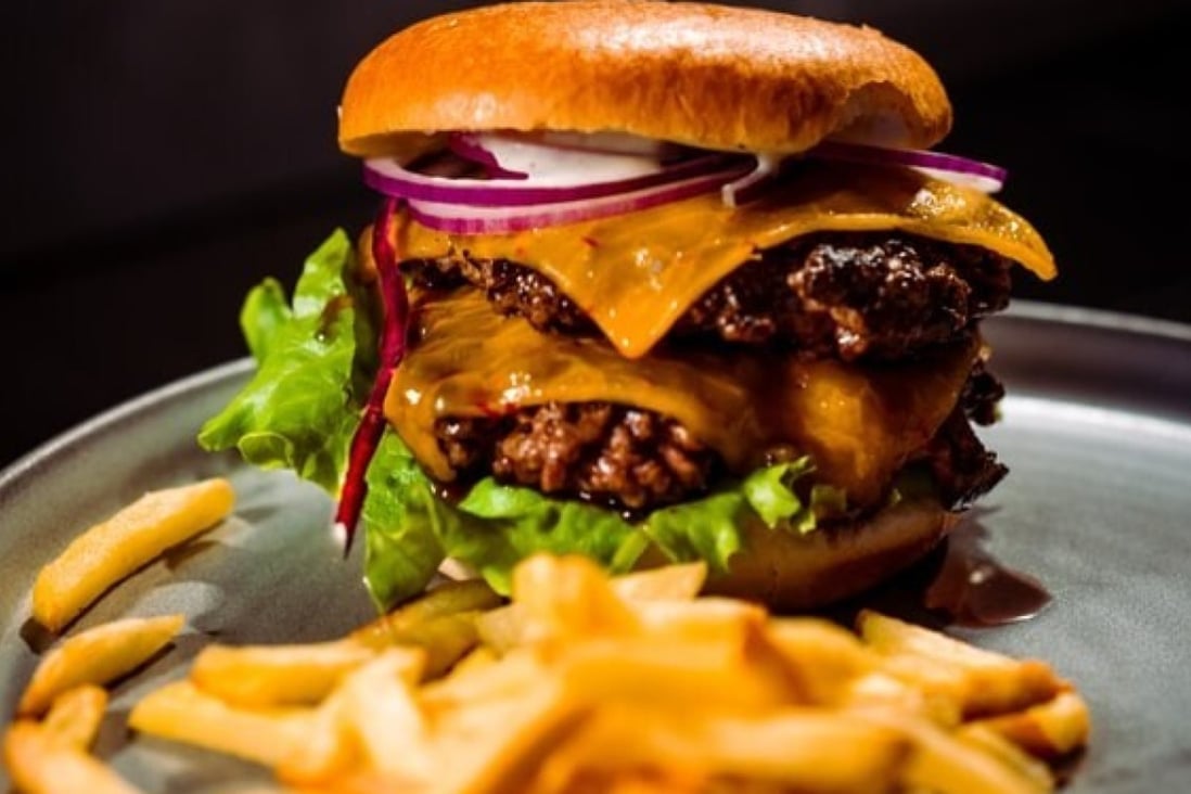 Dishes like this white truffle double cheeseburger may be delicious, but they are unlikely to make you feel as full as an unprocessed meal. Photo: @emanuelekstrom/Unsplash