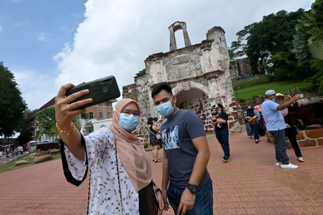 People take selfies at a tourist attraction in Malacca, Malaysia, in December 2020. Photo: Xinhua