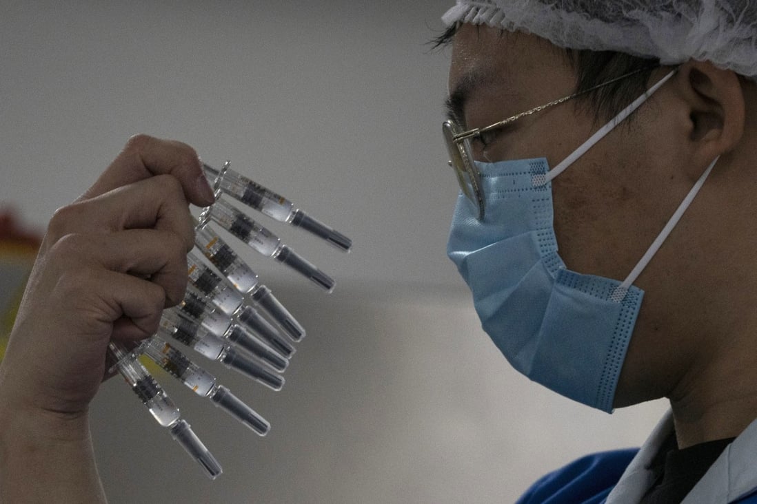 A worker inspects syringes of a Covid-19 vaccine produced by Sinovac at its factory in Beijing. Photo: AP