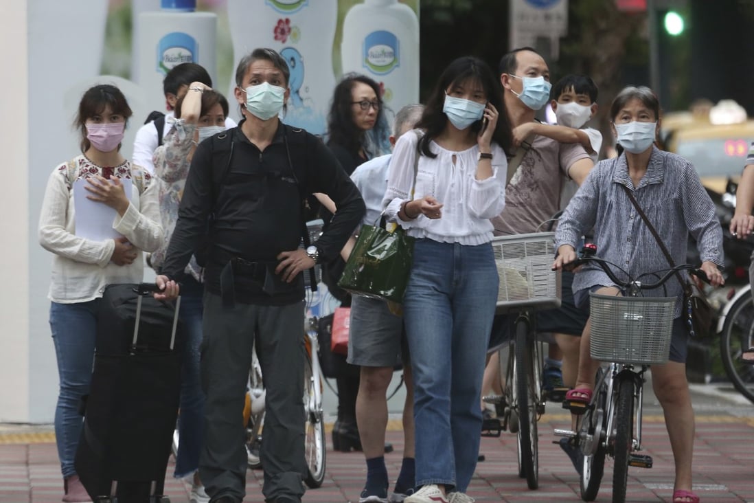 People wearing face masks to protect against the spread of the coronavirus travel around Taipei on May 18. Well-established practices such as wearing masks, transparency and trust in science have helped Taiwan assemble one of the world’s must successful Covid-19 pandemic responses. Photo: AP