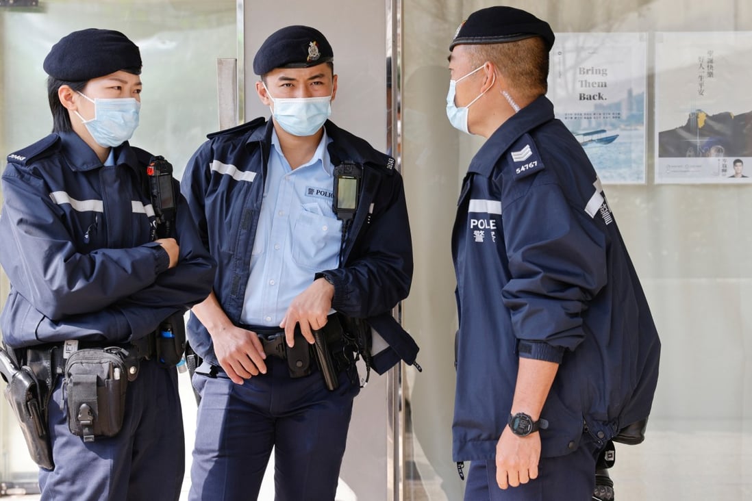 Police stand guard outside the office of one of the arrested, district councillor Lester Shum, on Wednesday. Photo: Reuters