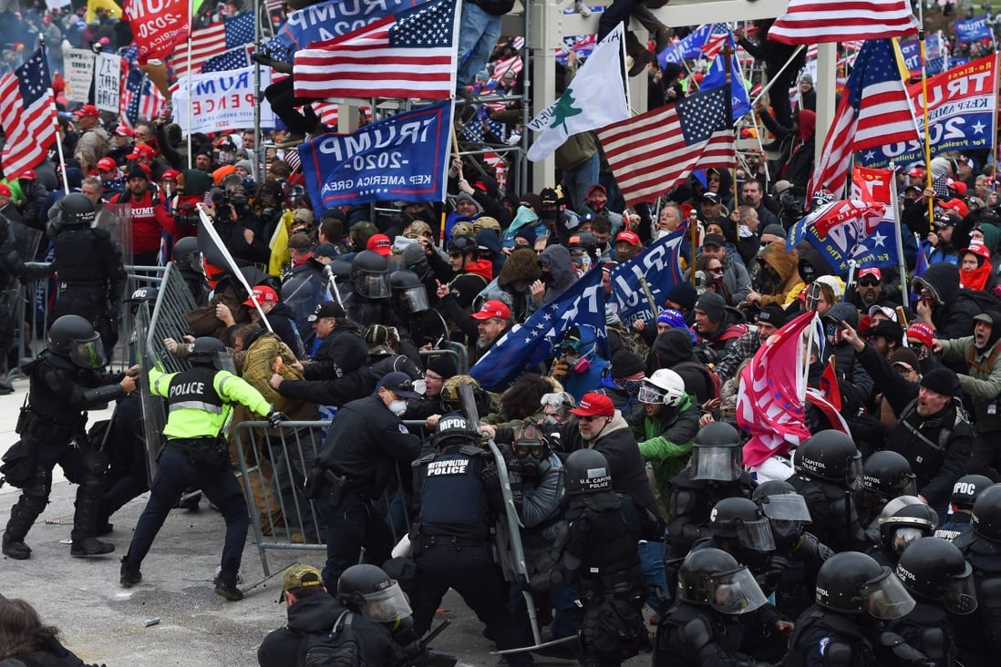 Supporters of outgoing President Donald Trump clash with police and security forces as they storm the barricades on their way to the US Capitol in Washington on January 6. Photo: AFP