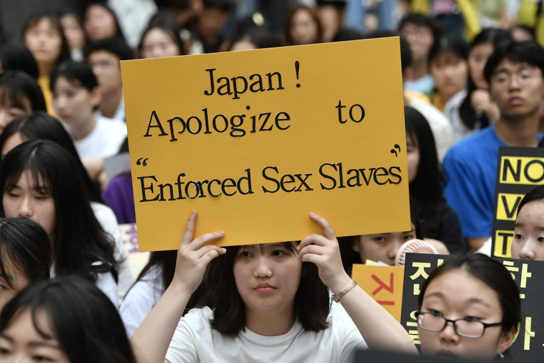 A South Korean protester holds a placard during an anti-Japanese demonstration in Seoul. Photo: AFP