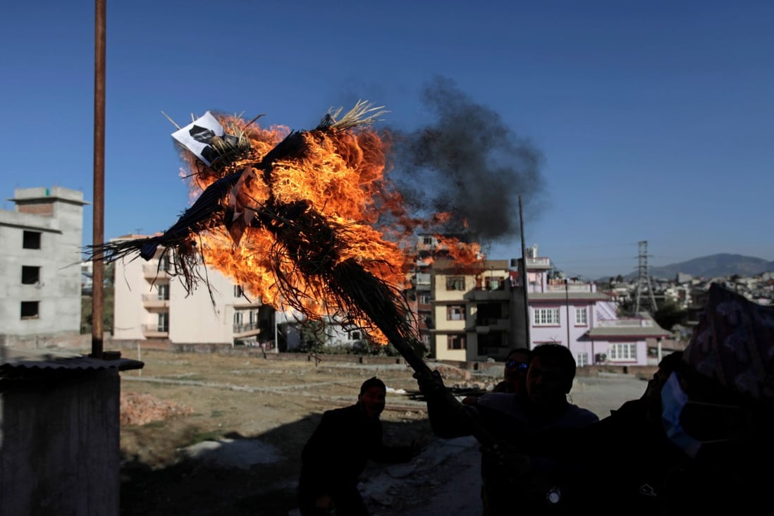 Protesters affiliated with a faction of the ruling Nepal Communist Party burn an effigy of Prime Minister K.P. Sharma Oli in Kathmandu on Thursday in protest over the dissolution of parliament. Photo: Reuters