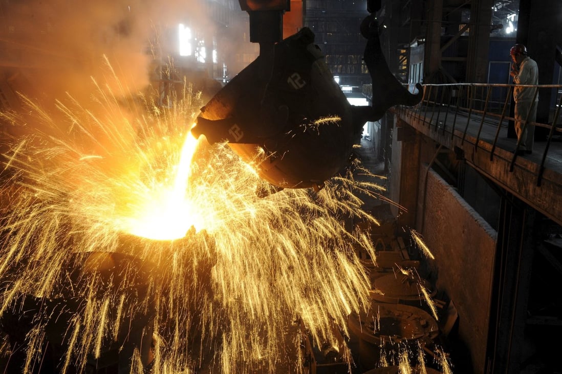 Molten iron is poured into a container at a steel plant in China. Photo: Reuters