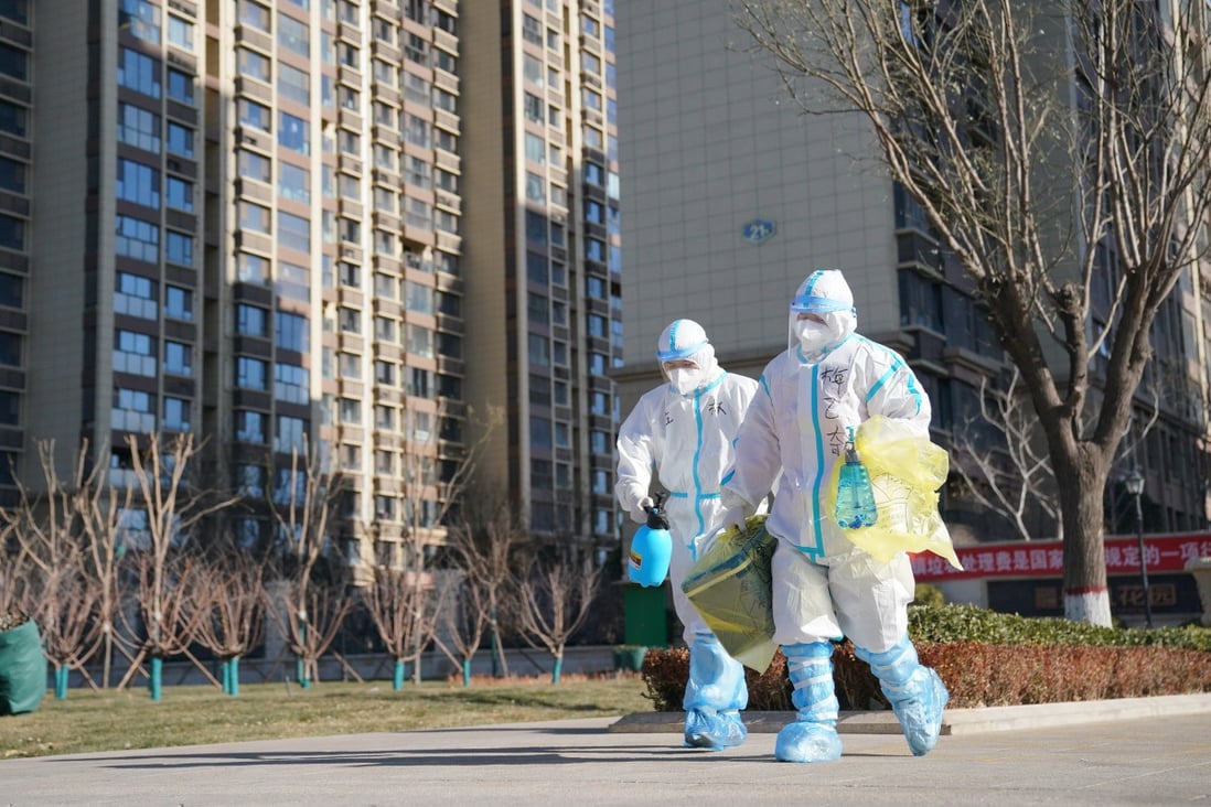 Workers carry a container of coronavirus test samples outside of a residential neighbourhood in Shijiazhuang in Hebei province on Friday. Photo: Xinhua via AP