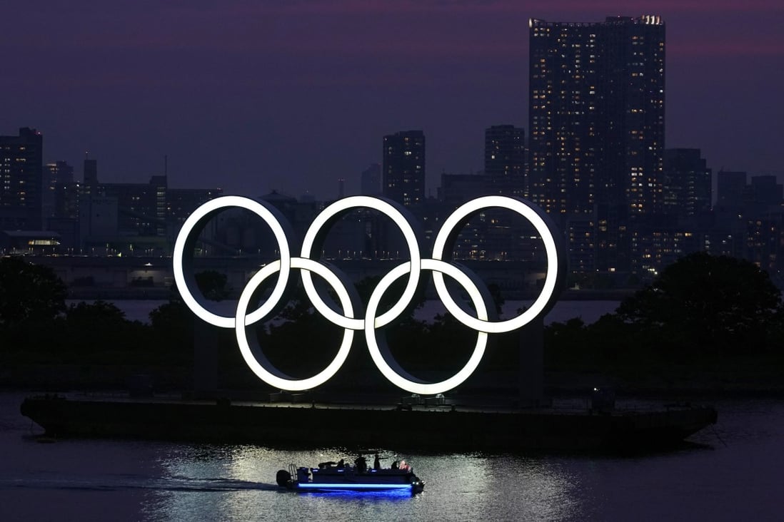 The Olympic rings float in the water at sunset in the Odaiba section in Tokyo last June. The Games have been postponed to July 23-August 8. Photo: AP